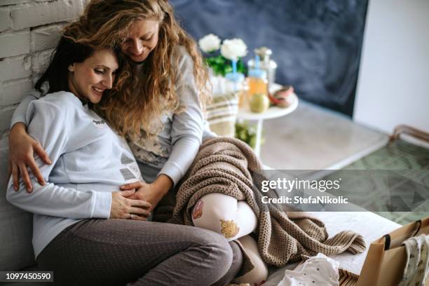 pregnant woman with  best friend - godparent stock pictures, royalty-free photos & images