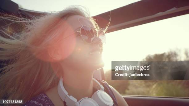 happy woman travelling in a car with sunroof - hot spanish women stock pictures, royalty-free photos & images