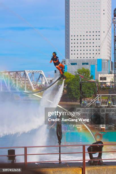 the fifth annual "pikachu outbreak" in yokohama (2018) - flyboarding performance - pikachu stock pictures, royalty-free photos & images