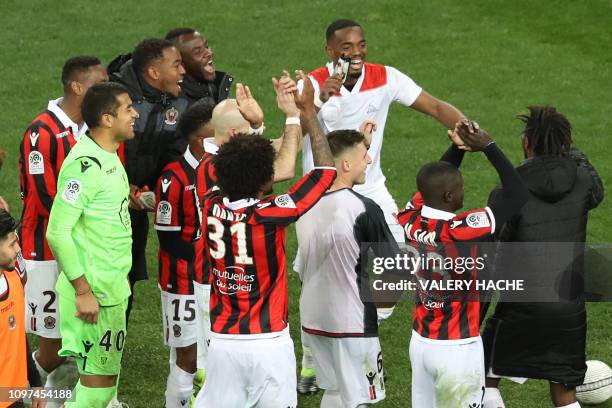 Nice's team players celebrate after winning at the end of the French L1 football match between OGC Nice and Olympique Lyonnais at the Allianz Riviera...