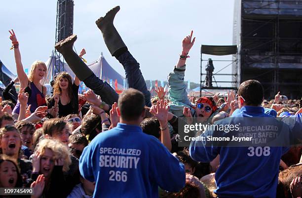 Music fan crowd surfs towards the safety stewards as You Me At Six perform live on the Main stage during the third and final day of Reading Festival...