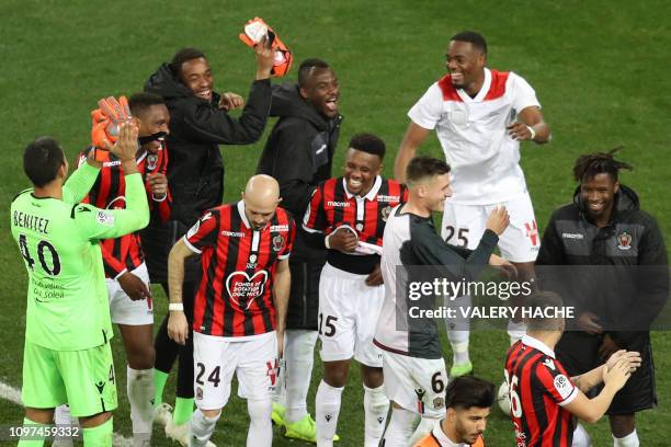 Nice's team players celebrate after winning at the end of the French L1 football match between OGC Nice and Olympique Lyonnais at the Allianz Riviera...