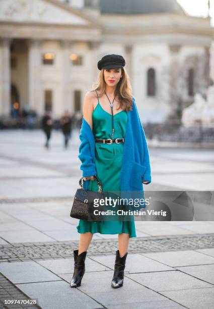 Alexandra Lapp is seen wearing a Selected Femme long oversized knit cardigan in petrol, styled with a silver buckled H&M cowboy belt, turquoise...