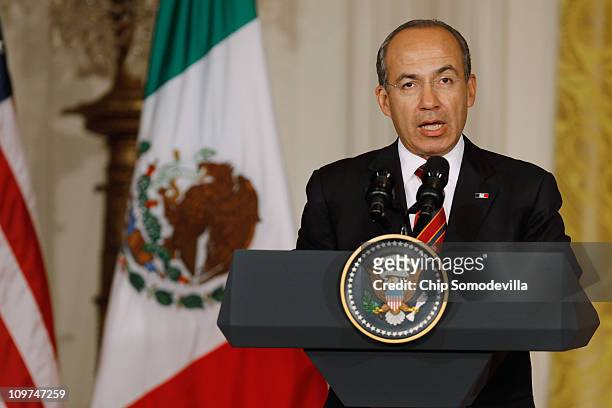 Mexican President Felipe Calderon answers reporters' questions during a joint news conference with U.S. President Barack Obama at the White House...