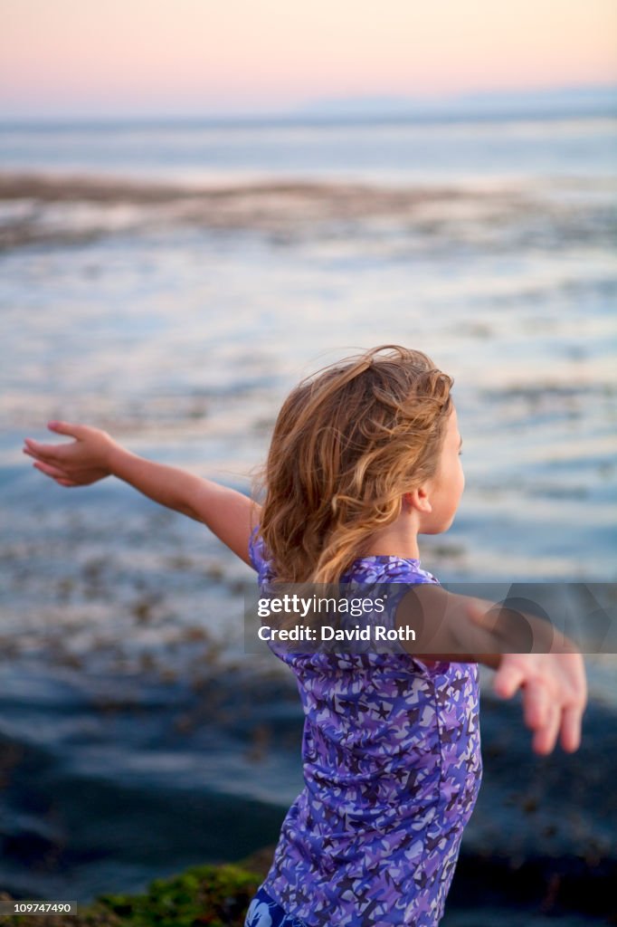 Girl facing the ocean