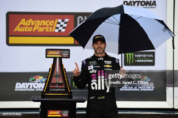 Jimmie Johnson, driver of the Ally Chevrolet, celebrates in victory lane after winning the Monster Energy NASCAR Cup Series Advance Auto Parts Clash...