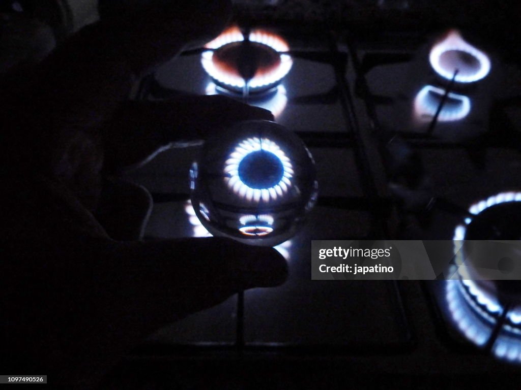 Gas flame in a kitchen through a glass sphere