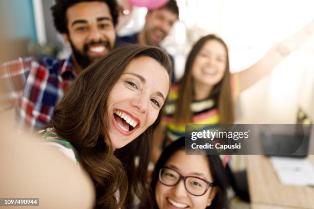 happy friends talking a selfie in the office - balloon woman party stock pictures, royalty-free photos & images