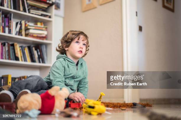 childhood at home with toys, young boy looking to the right - jouet garçon photos et images de collection