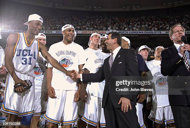Final Four: UCLA coach Jim Harrick victorious, shaking hands with Ed O'Bannon after winning National Chamionship game vs Arkansas at...