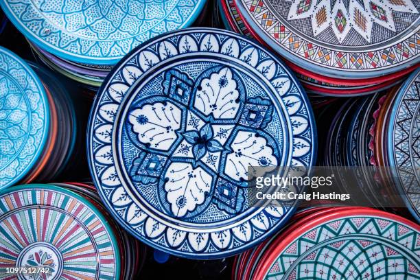 selection of plates, bowls and porcelain for sale in the market square souq of marrakesh - ceramic designs stock pictures, royalty-free photos & images