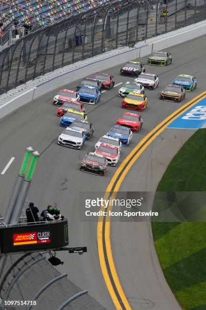 Kyle Busch, driver of the M&Ms Chocolate Bar Toyota, leads the field on the first lap during the Advance Auto Parts Clash on February 10, 2019 at...