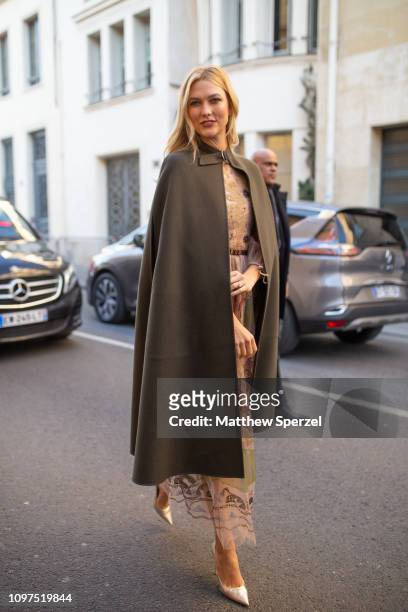 Karlie Kloss is seen on the street attending CHRISTIAN DIOR during Paris Haute Couture Fashion Week wearing Dior outfit with hunter green cloak on...