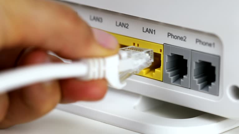 Plug Into Router Phone A woman hand plugs in network cable into home router network plug 동영상 ...