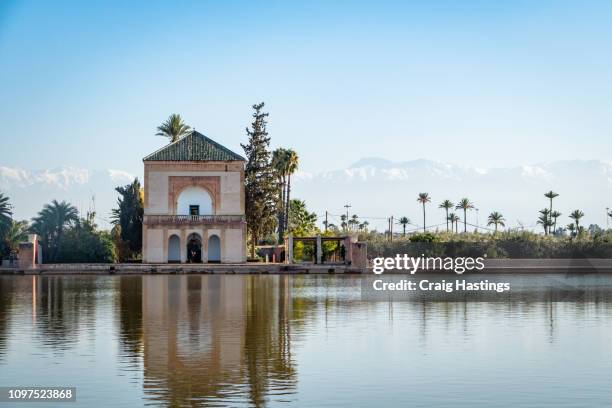 view of the famous landmark menara gardens in marrakesh morocco - atlas maroc stock pictures, royalty-free photos & images