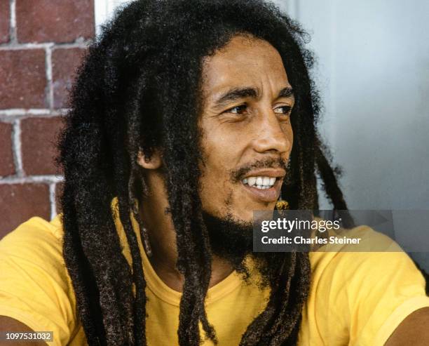 Bob Marley relaxes with friends in front of his house at 56 Hope Road on July 9, 1979 in Kingston, Jamaica.