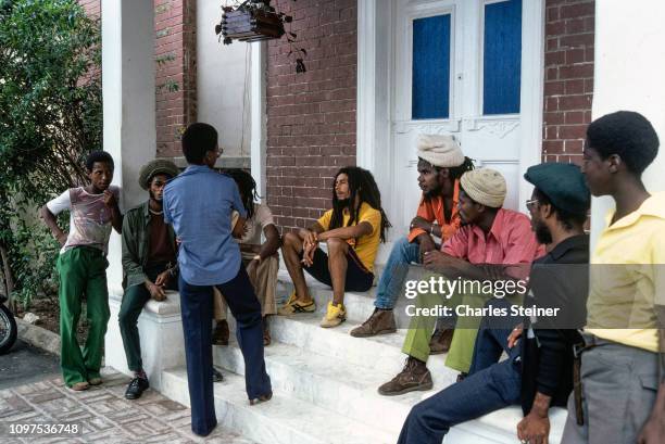 Bob Marley relaxes with friends in front of his house at 56 Hope Road on July 9, 1979 in Kingston, Jamaica.