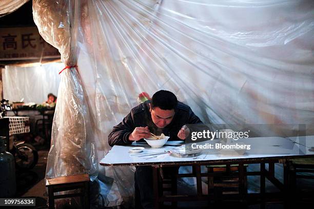 Man eats a bowl of dumplings at a night market in Chuzhou, Anhui Province, China, on Wednesday, March 2, 2011. As Chinese Premier Wen Jiabao this...