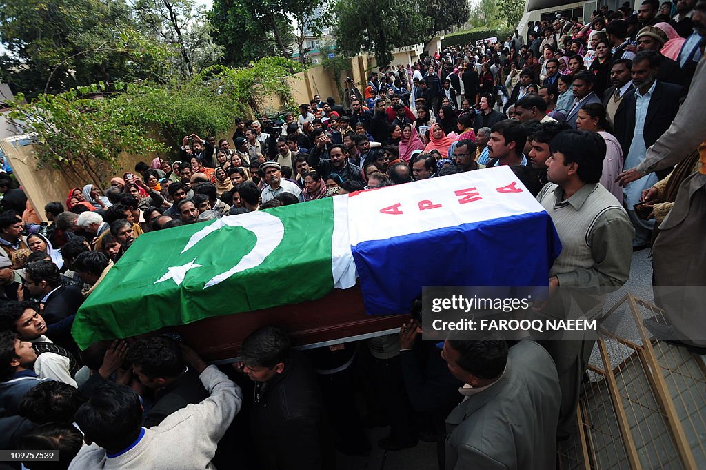 Pakistani Christians carry the coffin of