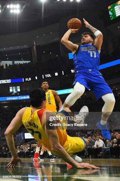 Luka Doncic of the Dallas Mavericks shoots over Ersan Ilyasova of the Milwaukee Bucks during the second half of a game at Fiserv Forum on January 21,...