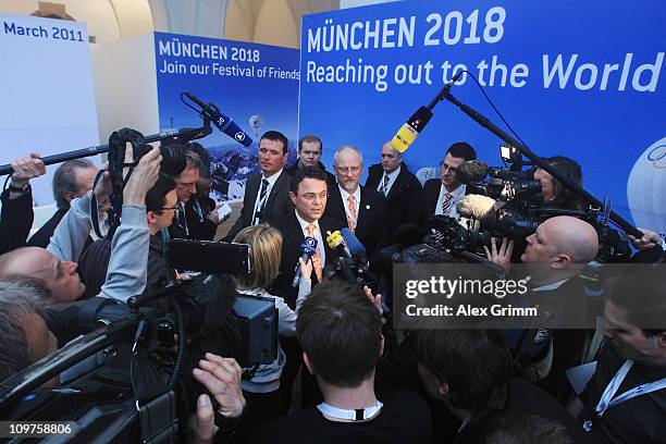 German Interior Minister Hans-Peter Friedrich addresses the media during a press conference at the Munich 2018 media center on March 4, 2011 in...