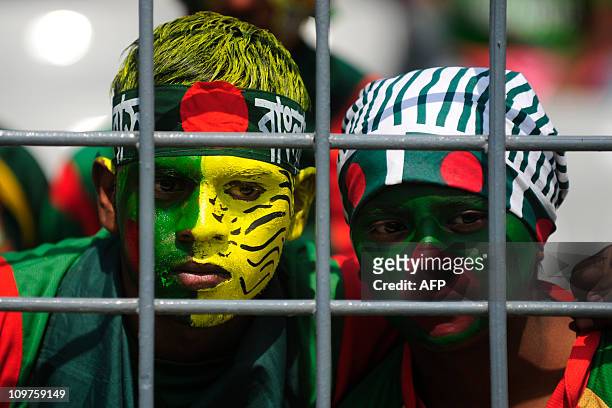 Bangladeshi cricket fans, their faces painted in the national colours, wait for play to start in the Cricket World Cup tournament match between...