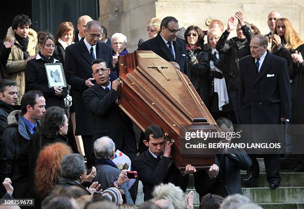 People applaud as the coffin of French actress Annie Girardot leaves Paris Saint-Roch church, after the funeral ceremony, on March 4, 2011. Girardot...