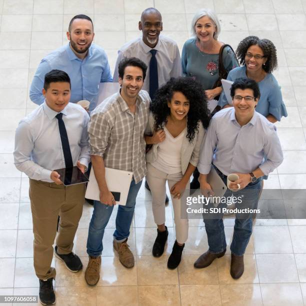high angle view of cheerful group employee photo - organized group photo stock pictures, royalty-free photos & images