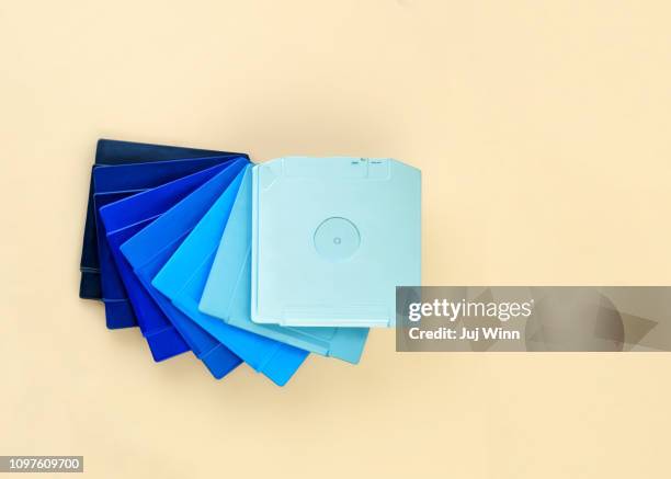 stack of computer disk drives painted in a blue gradient - computer disk stock pictures, royalty-free photos & images