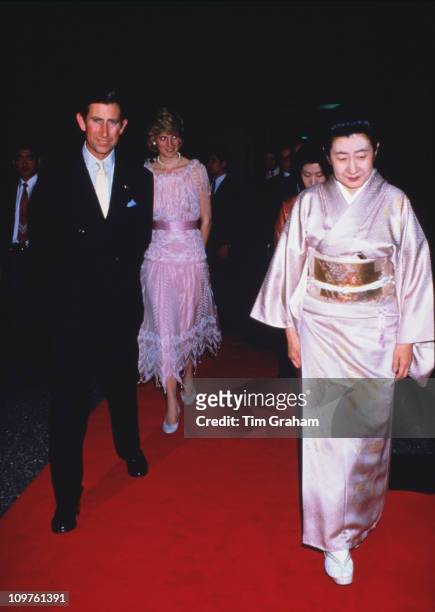 Princess Diana and Prince Charles on their way to to a dinner in Kyoto, Japan, 9th May 1986. The princess is wearing a dress by Zandra Rhodes.