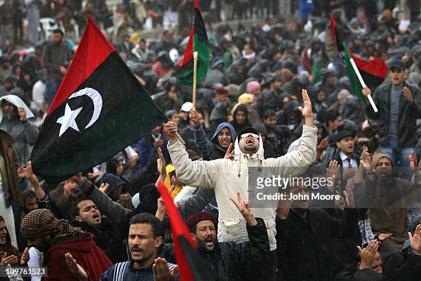 Opposition supporters pray in the rain March 4, 2011 in Benghazi, Libya. Thousands of protesters gathered for Friday prayers and listened to a call...