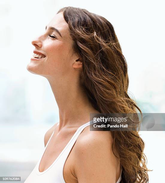 young woman smiling with eyes closed, side view - woman with eyes closed stock pictures, royalty-free photos & images