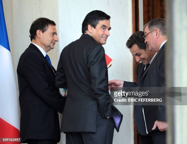 French President Nicolas Sarkozy listens to Justice Minister Michel Mercier next to Prime Minister Francois Fillon and Energy and Industry Minister...