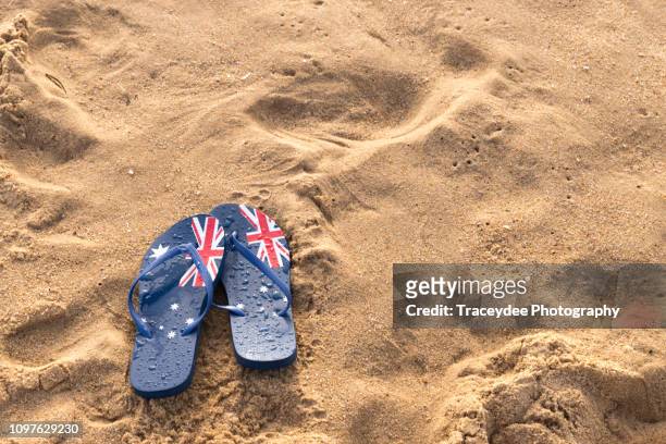 australia flag thongs or flip-flops on an australian beach - australia day stock pictures, royalty-free photos & images