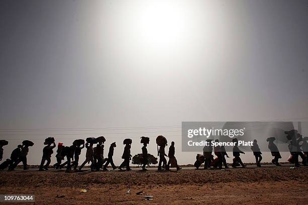 Thousands of Bangladeshi migrant workers who recently crossed into Tunisia from Libya walk to a United Nations displacement camp March 04, 2011 in...