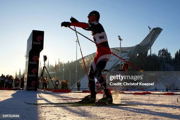 Mario Stecher of Austria crosses the finish line ahead of Tino Edelmann of Germany to win the gold medal in the Nordic Combined Team 4x5km race...