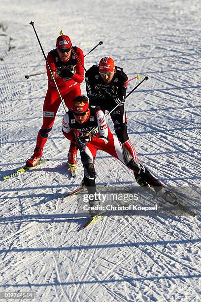 David Kreiner of Austria, Bjoern Kircheisen of Germany and Haavard Klemetsen of Norway compete in the Nordic Combined Team 4x5km race during the FIS...