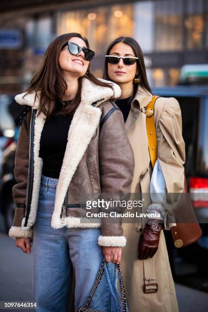 Julia Haghjoo, wearing a long beige trench coat, burgundy gloves and brown bag and Sylvia Haghjoo, wearing black top, grey jacket with fur details...