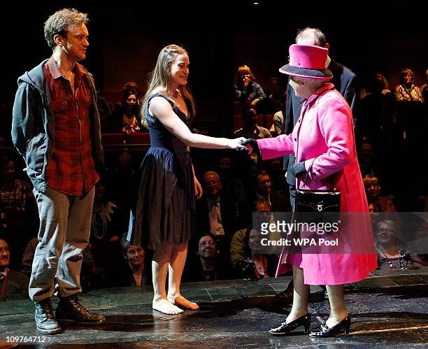 Queen Elizabeth II speaks to Romeo and Juliet actors, Sam Troughton and Mariah Gale during her visit to the Royal Shakespeare Theatre on March 4,...