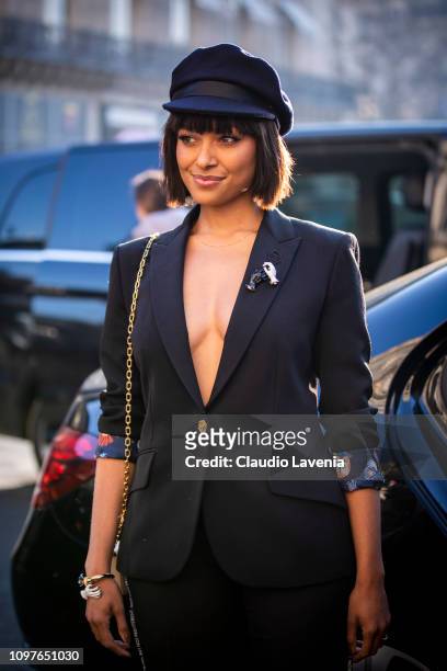 Kat Graham, wearing a black suit, black hat and cream bag, is seen outside Schiaparelli during Paris Fashion Week - Haute Couture Spring Summer 2019...