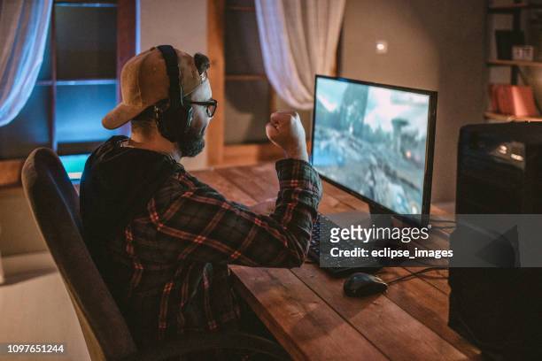 teenager playing games on pc - desktop pc stock pictures, royalty-free photos & images