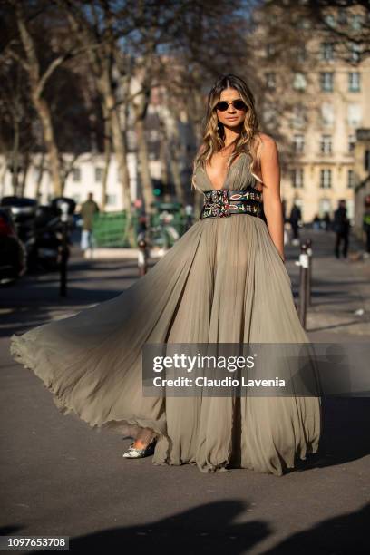 Thassia Naves, wearing a long military green dress with a decorated belt and Dior bag, is seen outside Christian Dior during Paris Fashion Week -...