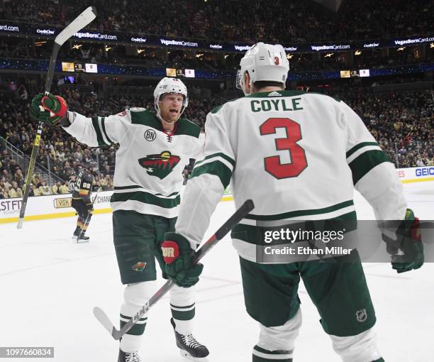 Eric Staal and Charlie Coyle of the Minnesota Wild celebrate after Staal assisted Coyle on a third-period goal against the Vegas Golden Knights...
