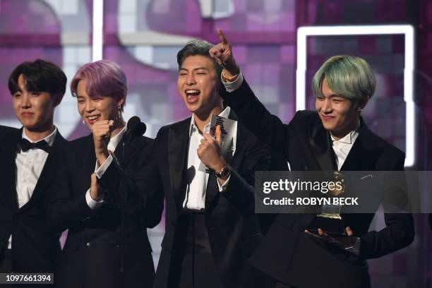 South Korean band BTS presents the award for Best R&B Album during the 61st Annual Grammy Awards on February 10 in Los Angeles.