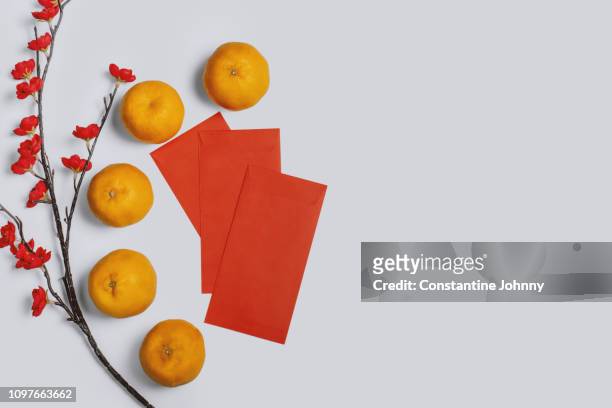 chinese new year red envelope and mandarin orange fruit on white background - chinese new year red envelope stock pictures, royalty-free photos & images