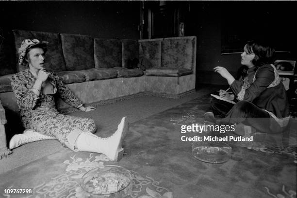 Singer David Bowie being interviewed at his ground floor flat at Haddon Hall, where he has been redecorating the ceiling in silver paint, Beckenham,...