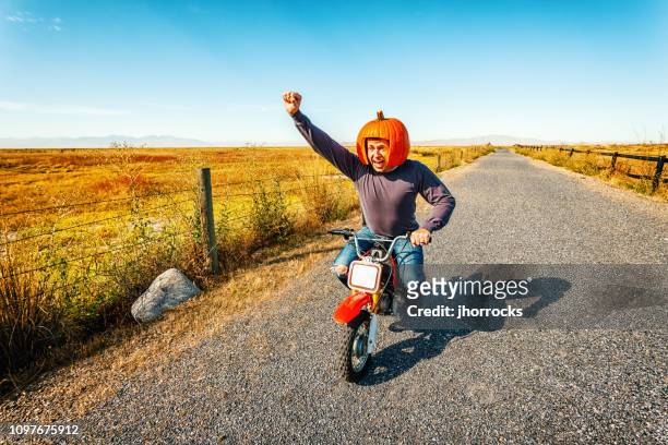 pumpkin helmet motorcycle racer - october stock pictures, royalty-free photos & images
