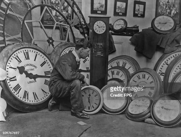Workman removing the clocks at the close of the British Empire Exhibition held at Wembley in London, England in 1924.