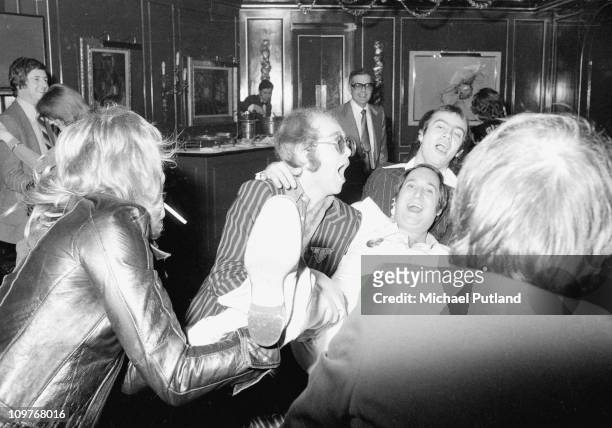 Elton John, Neil Sedaka and Bernie Taupin partying in London, England in 1975.