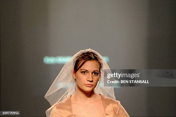 Model wears a creation from a collection entitled 'Kate Middleton Collection' during a fashion show by students at the UCL in London, on March 4,...